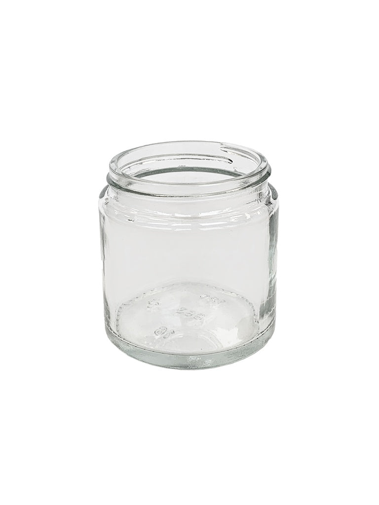 Comandante Kaffebønne Glas, Klart, har en bred åbning og kort cylindrisk form for optimal opbevaring af kaffebønner, sat mod en almindelig hvid baggrund.