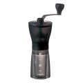 Hario Keramisk Kaffekværn Mini Slim+ er en sort og gennemsigtig manuel kværn med tophåndsving. Den har "1" og "2" målemarkeringer og Hario-logoet, perfekt til friskmalet kaffebønner hver morgen.